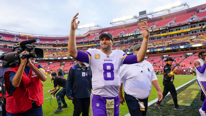 Kirk Cousins smiles and waves as he leaves FedEx Field